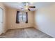 Neutral bedroom offering a ceiling fan, window, and closet providing a calming atmosphere at 18182 W Desert Ln, Surprise, AZ 85388