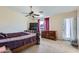 Bedroom featuring a window overlooking the backyard, complemented by neutral walls and carpet flooring at 18182 W Desert Ln, Surprise, AZ 85388