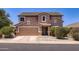 Charming two-story home with a two-car garage, desert landscaping, and a classic suburban appeal at 18182 W Desert Ln, Surprise, AZ 85388
