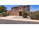 Two-story home with a two-car garage, desert landscaping, and a well-maintained exterior at 18182 W Desert Ln, Surprise, AZ 85388