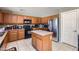 Well-equipped kitchen featuring stainless steel appliances, central island and ample cabinet space at 18182 W Desert Ln, Surprise, AZ 85388