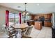 Bright eat-in kitchen featuring ample cabinet space, modern appliances, and a view of the backyard at 18182 W Desert Ln, Surprise, AZ 85388