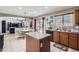 Open kitchen with a central island, seamlessly connecting to dining and living areas at 18182 W Desert Ln, Surprise, AZ 85388