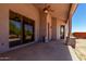 Covered back patio with ceiling fan, featuring large sliding glass doors at 19621 W Minnezona Ave, Litchfield Park, AZ 85340