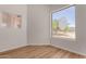 Bright bedroom featuring new flooring, a large window creating an inviting atmosphere at 19621 W Minnezona Ave, Litchfield Park, AZ 85340