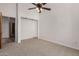 Bedroom featuring a ceiling fan, carpeted floor, and closet at 19621 W Minnezona Ave, Litchfield Park, AZ 85340