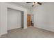 Bedroom featuring a ceiling fan, carpeted floor, and closet at 19621 W Minnezona Ave, Litchfield Park, AZ 85340