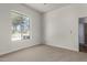 Bedroom featuring a ceiling fan, carpeted floor, and a large window at 19621 W Minnezona Ave, Litchfield Park, AZ 85340