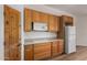 Kitchen featuring wood cabinets, microwave, and an adjacent refrigerator at 19621 W Minnezona Ave, Litchfield Park, AZ 85340