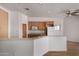 Open-concept kitchen featuring light wood cabinets, and stainless steel appliances at 19621 W Minnezona Ave, Litchfield Park, AZ 85340