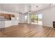 Open living room with wood floors, sliding glass doors, a fireplace and large windows at 19621 W Minnezona Ave, Litchfield Park, AZ 85340