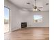 Spacious living room with wood flooring, sliding glass door, and neutral walls creating an inviting atmosphere at 19621 W Minnezona Ave, Litchfield Park, AZ 85340