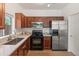Well-lit kitchen featuring stainless steel appliances and white countertops complemented by wood cabinets at 2150 E Bell Rd # 1088, Phoenix, AZ 85022
