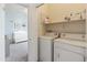 Laundry room featuring a washer, dryer and shelving for supplies, located next to bedroom at 2150 E Bell Rd # 1088, Phoenix, AZ 85022