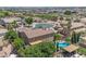 An aerial view reveals a backyard oasis complete with a sparkling pool and lush landscaping at 21575 E Twin Acres Ct, Queen Creek, AZ 85142