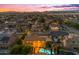 Beautiful home at dusk, showcasing a sparkling pool and serene neighborhood surroundings at 21575 E Twin Acres Ct, Queen Creek, AZ 85142