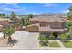 An aerial perspective of a two-story home features lush landscaping and a large driveway at 21575 E Twin Acres Ct, Queen Creek, AZ 85142