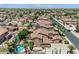 Expansive aerial view of a desert community featuring tile roof homes and private pools at 21575 E Twin Acres Ct, Queen Creek, AZ 85142