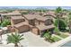 Aerial view of a stunning home with a spacious driveway and beautifully landscaped front yard at 21575 E Twin Acres Ct, Queen Creek, AZ 85142