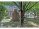 Spacious backyard featuring a custom outdoor kitchen, mature trees, and covered patio at 21575 E Twin Acres Ct, Queen Creek, AZ 85142