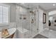 Modern bathroom with glass shower, bench, and marble tile at 21575 E Twin Acres Ct, Queen Creek, AZ 85142