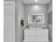 Bathroom featuring a modern sink, lighted mirror, white cabinets, and a shower at 21575 E Twin Acres Ct, Queen Creek, AZ 85142