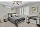 Cozy bedroom with neutral walls, carpet, ceiling fan, window with shutters, and a comfortable bed at 21575 E Twin Acres Ct, Queen Creek, AZ 85142