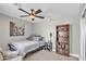Cozy bedroom features neutral walls, ceiling fan, and bookshelves at 21575 E Twin Acres Ct, Queen Creek, AZ 85142