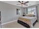Comfortable bedroom with ceiling fan, window view, and neutral decor at 21575 E Twin Acres Ct, Queen Creek, AZ 85142