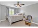 Well lit bedroom with many pillows and a white comfy chair at 21575 E Twin Acres Ct, Queen Creek, AZ 85142