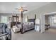 Well-lit bedroom featuring a four-poster bed, massage chair, and large dresser with light walls at 21575 E Twin Acres Ct, Queen Creek, AZ 85142