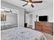 Bedroom with mirrored closet doors, dresser, and ceiling fan at 21575 E Twin Acres Ct, Queen Creek, AZ 85142