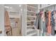 Organized walk-in closet with built-in shelving for shoes and clothing at 21575 E Twin Acres Ct, Queen Creek, AZ 85142