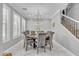 Elegant dining room with chandelier, large windows, and seating for eight at 21575 E Twin Acres Ct, Queen Creek, AZ 85142