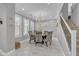 Bright dining room with large windows, chandelier, and seating for eight at 21575 E Twin Acres Ct, Queen Creek, AZ 85142