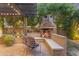Cozy outdoor fireplace with comfortable seating, perfect for relaxing evenings at 21575 E Twin Acres Ct, Queen Creek, AZ 85142