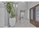 Bright foyer with elegant marble floors, a decorative front door, and a plant in the entrance at 21575 E Twin Acres Ct, Queen Creek, AZ 85142