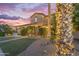 Attractive two-story house with a well-manicured lawn and mature palm trees, offering a serene and inviting ambiance at 21575 E Twin Acres Ct, Queen Creek, AZ 85142