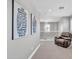 Upstairs hallway with modern light fixture and leather armchair at 21575 E Twin Acres Ct, Queen Creek, AZ 85142
