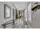 Well-lit hallway featuring elegant tile flooring, shuttered windows, and stylish decor at 21575 E Twin Acres Ct, Queen Creek, AZ 85142