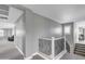 Upstairs hallway with gray walls, white trim, and decorative wrought iron staircase railing at 21575 E Twin Acres Ct, Queen Creek, AZ 85142