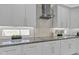 Clean and contemporary kitchen with mosaic backsplash and modern cabinetry at 21575 E Twin Acres Ct, Queen Creek, AZ 85142