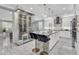 Modern kitchen with a marble island, sleek bar stools, and a climate-controlled wine storage unit at 21575 E Twin Acres Ct, Queen Creek, AZ 85142