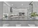 Modern kitchen featuring gray countertops, white cabinets, and barstool seating at 21575 E Twin Acres Ct, Queen Creek, AZ 85142