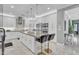 Bright, open kitchen featuring a spacious island, white cabinetry, and modern appliances at 21575 E Twin Acres Ct, Queen Creek, AZ 85142