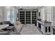 Stylish living room boasts built-in shelving, sleek seating, and bright window shutters at 21575 E Twin Acres Ct, Queen Creek, AZ 85142