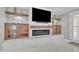 Cozy living room with a modern fireplace, built-ins, and a mounted TV at 21575 E Twin Acres Ct, Queen Creek, AZ 85142