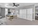 Large office with multiple workstations, neutral walls, a ceiling fan, and built-in storage cabinets at 21575 E Twin Acres Ct, Queen Creek, AZ 85142