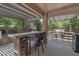 Custom outdoor kitchen with a built-in BBQ and bar seating, perfect for entertaining guests at 21575 E Twin Acres Ct, Queen Creek, AZ 85142