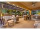 Charming covered patio with comfortable seating, a built-in grill, and a cozy dining area at 21575 E Twin Acres Ct, Queen Creek, AZ 85142